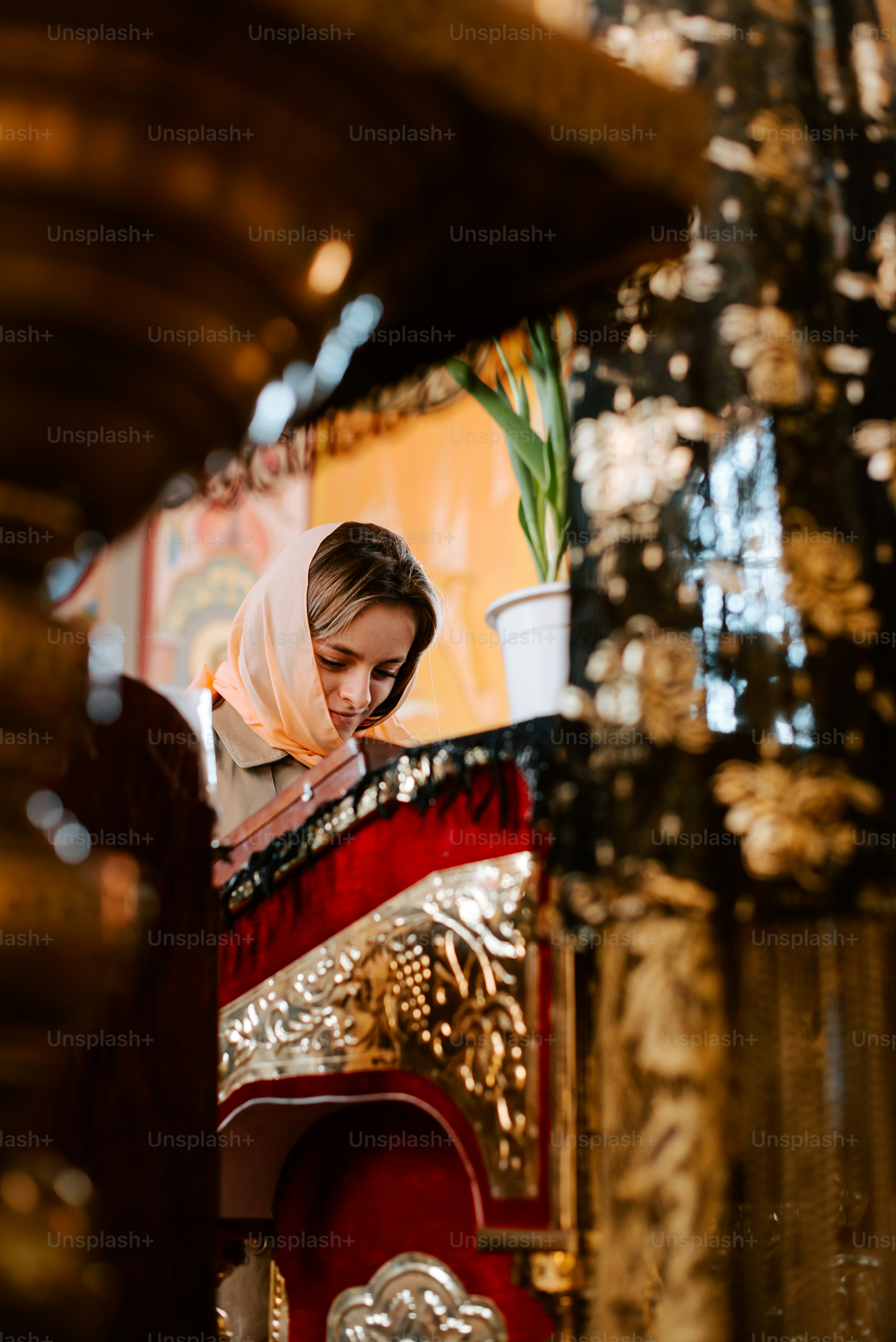 a woman is reading a book in a church