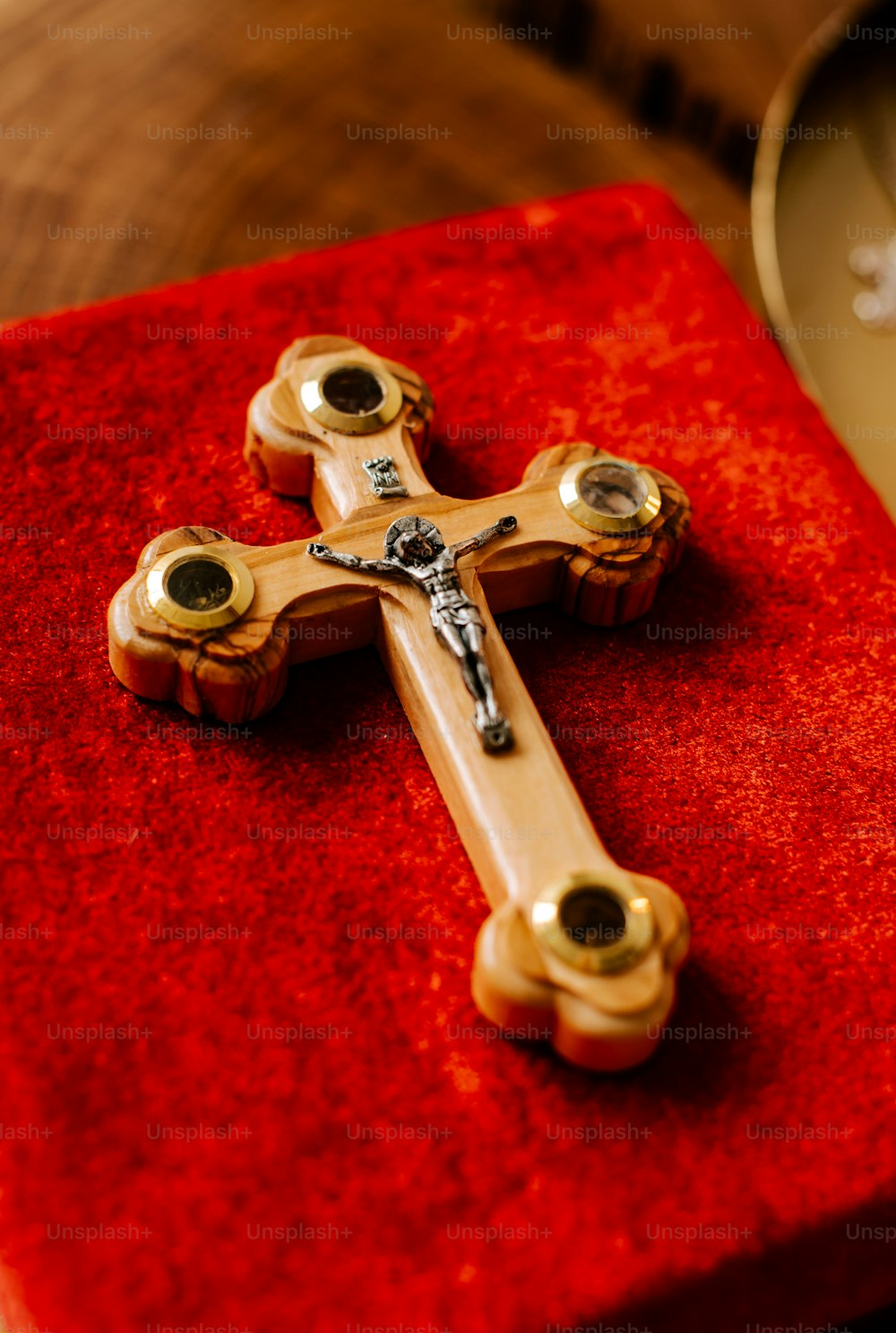 a wooden cross sitting on top of a red box