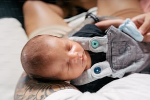 a person holding a baby wearing a pair of gloves