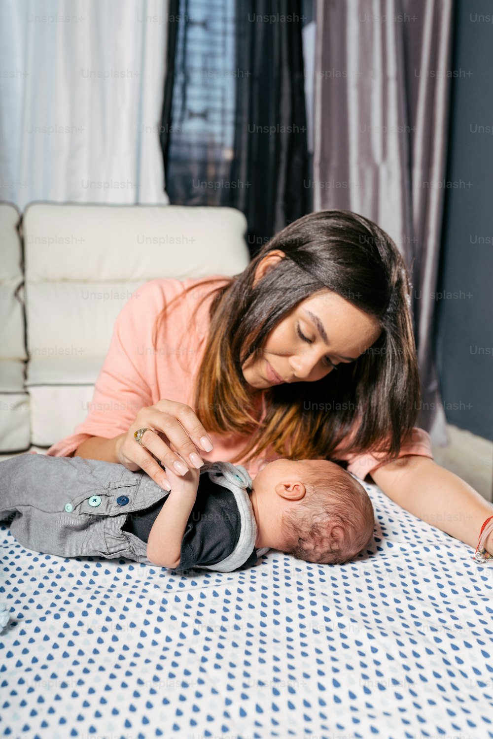 a woman laying on a bed holding a baby