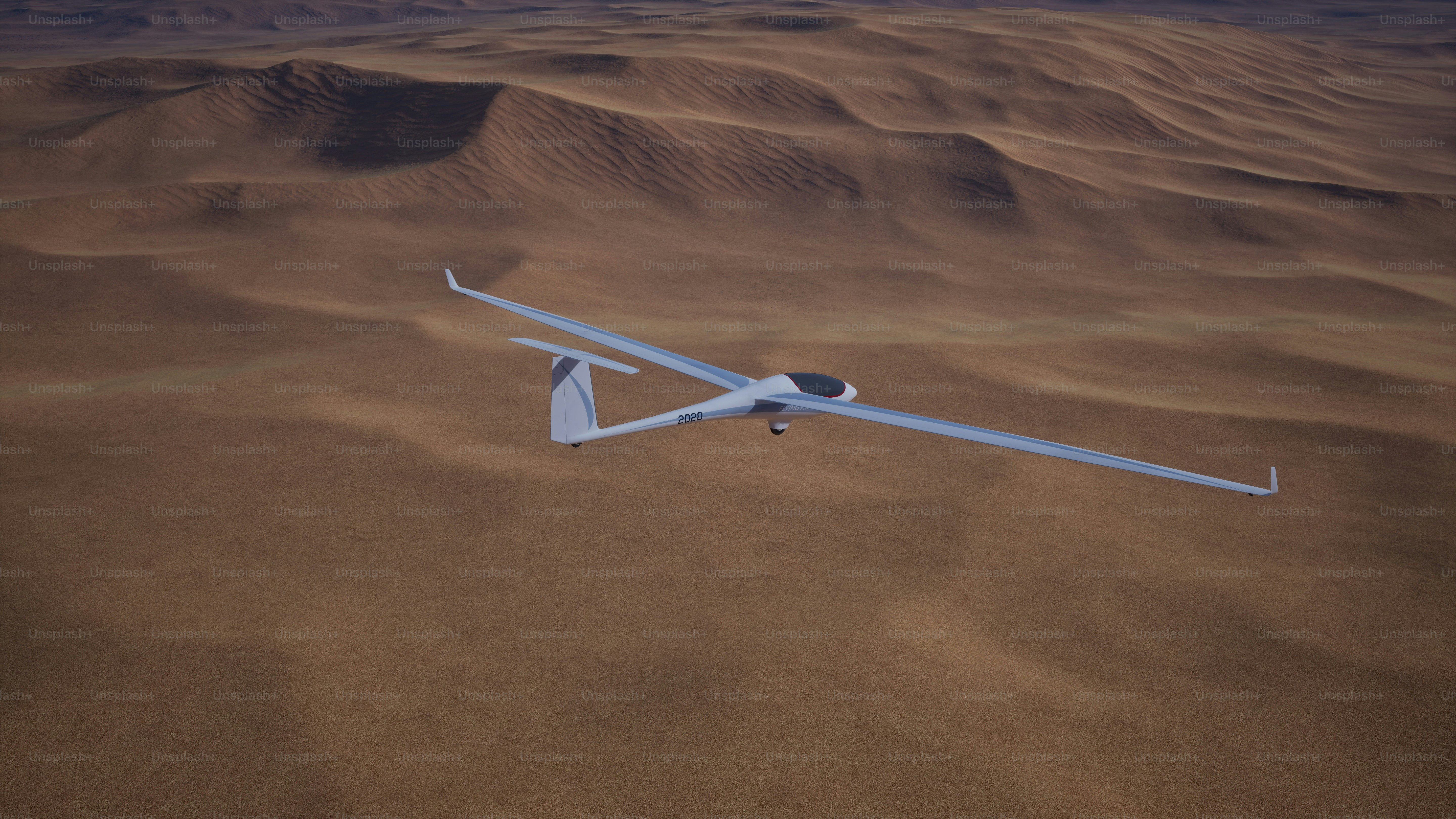 a small white airplane flying over a desert