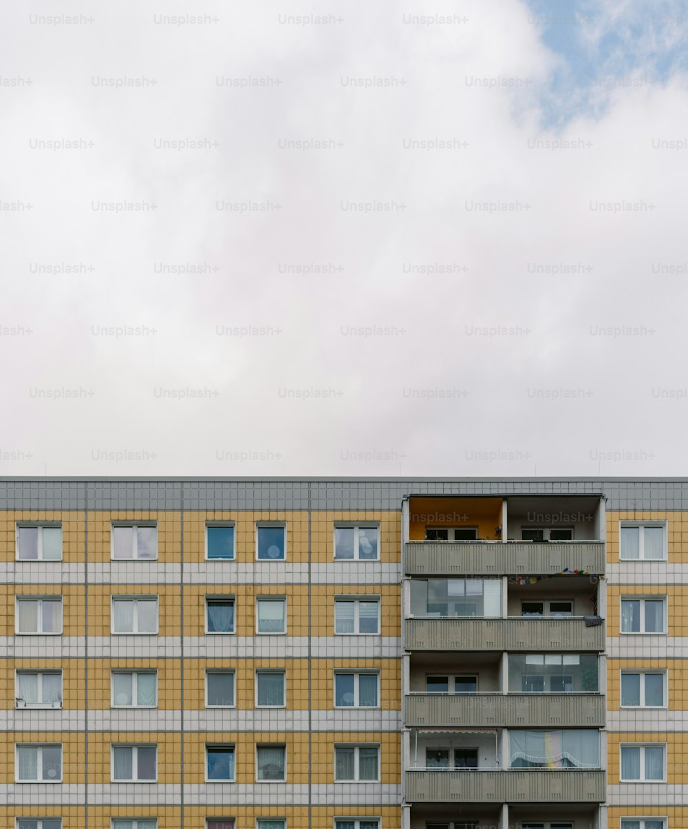 a tall building with many windows and balconies