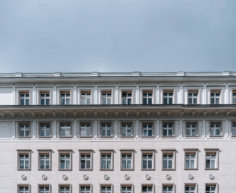 a large white building with a clock on the front of it