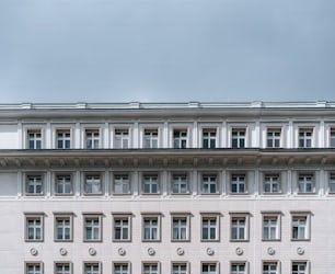 a large white building with a clock on the front of it