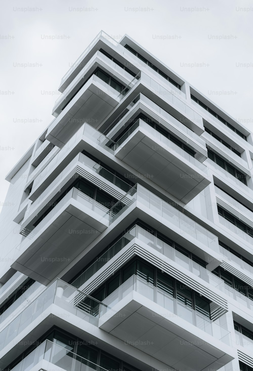 a tall building with balconies on the top of it