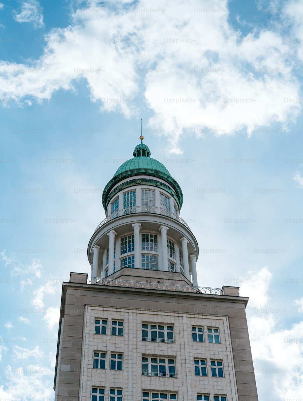 a tall building with a green dome on top