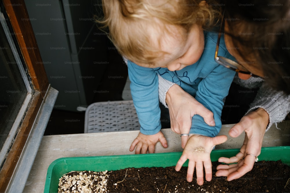 a woman and a child playing with dirt