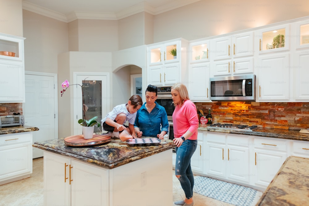 a group of people standing around a kitchen island