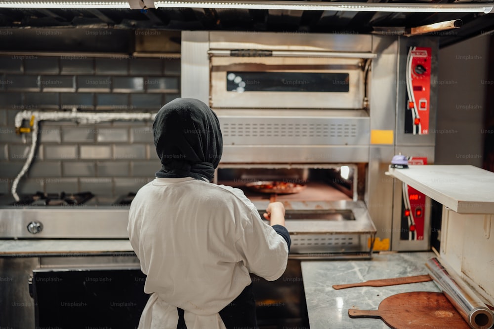 a person in a white coat is in a kitchen