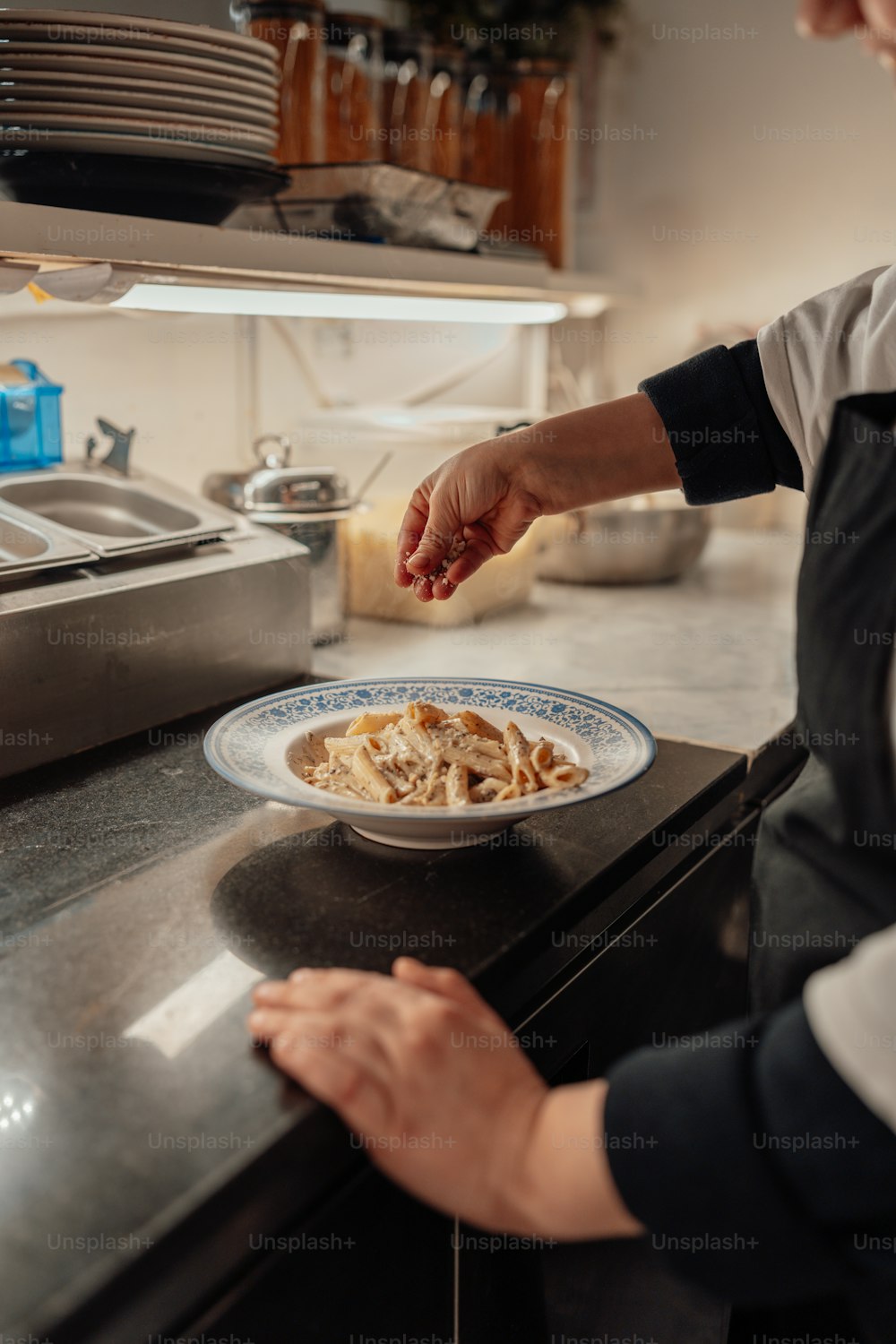 a woman putting a plate of food on a counter