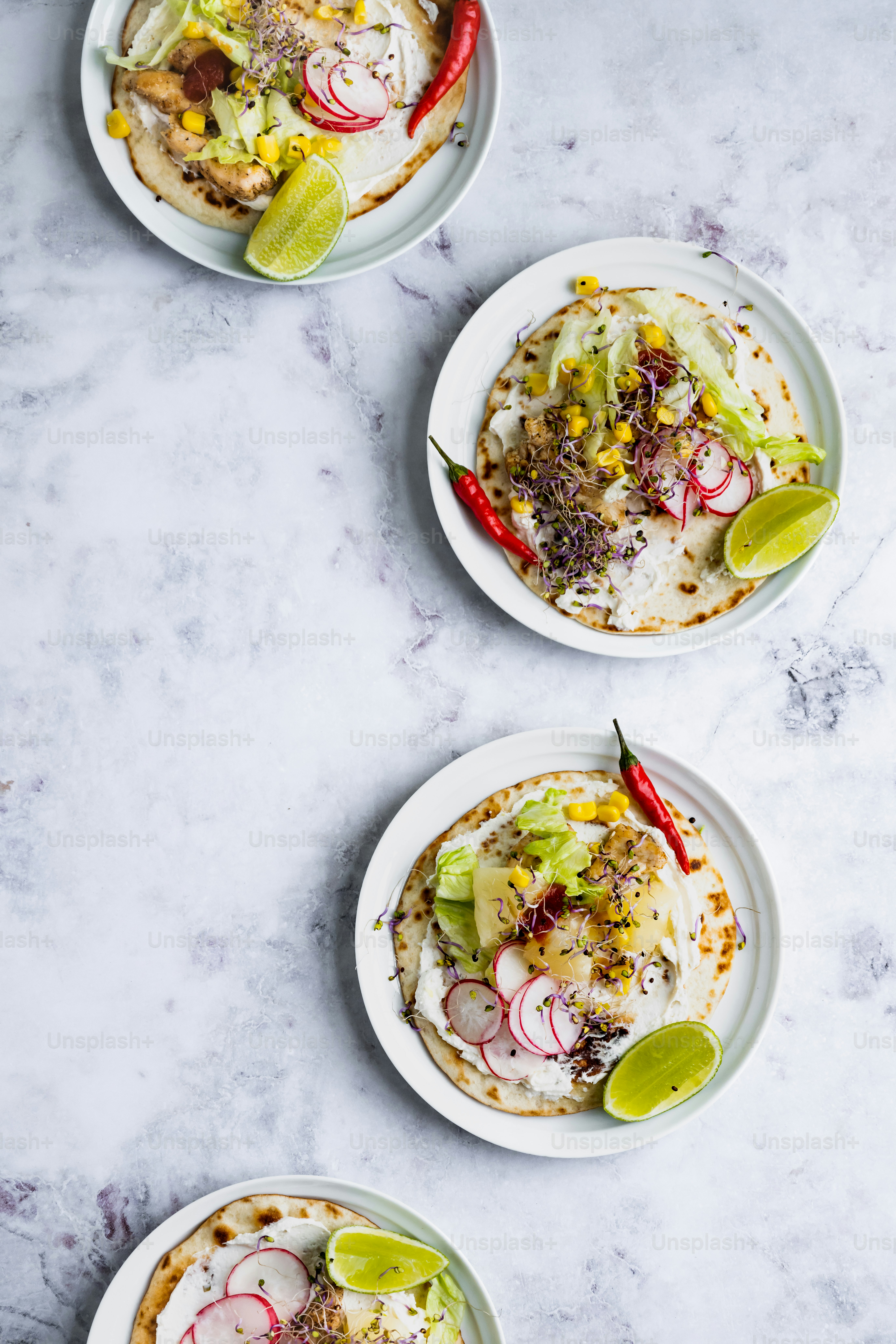 three plates of food on a marble table