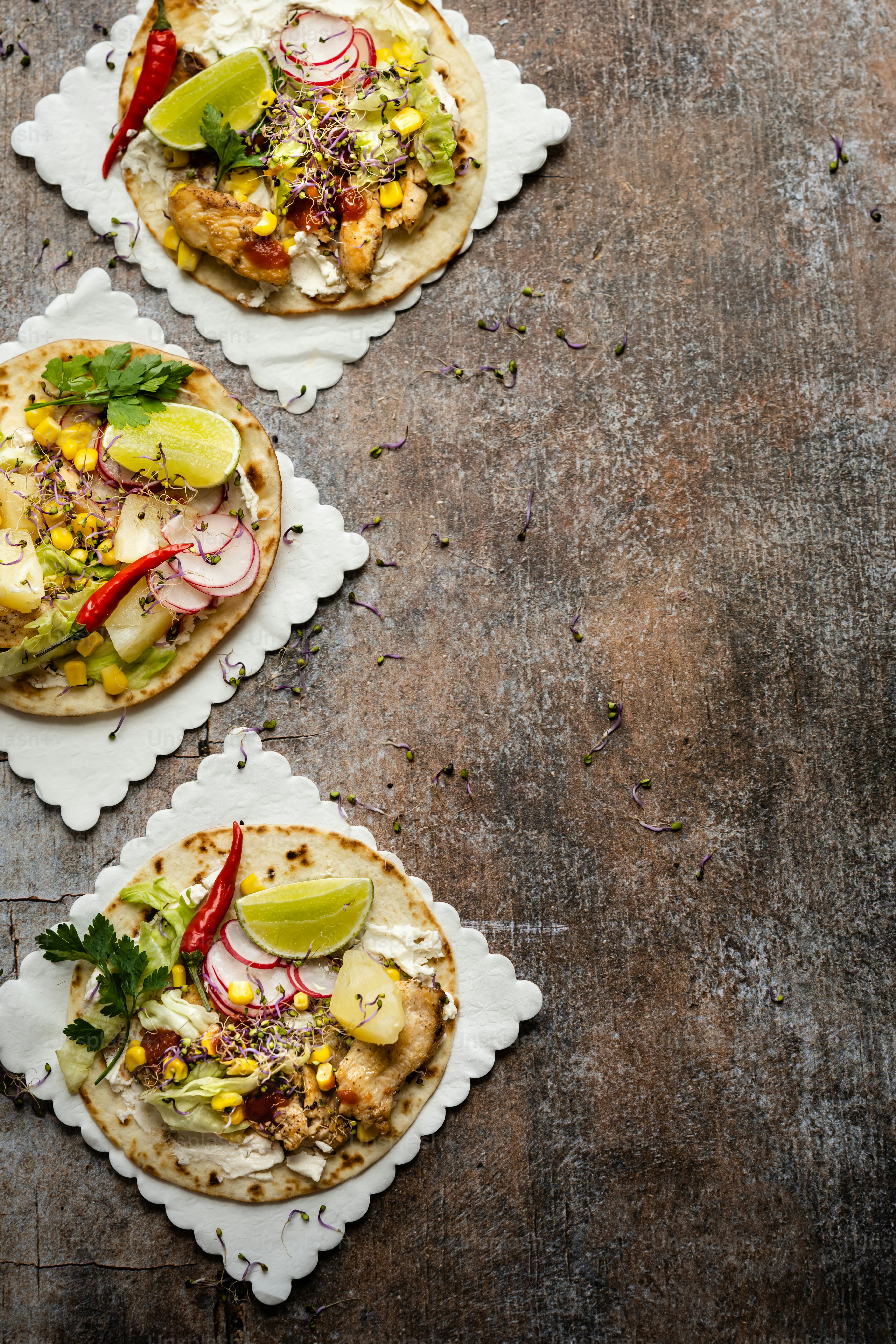 three plates of food on a wooden table