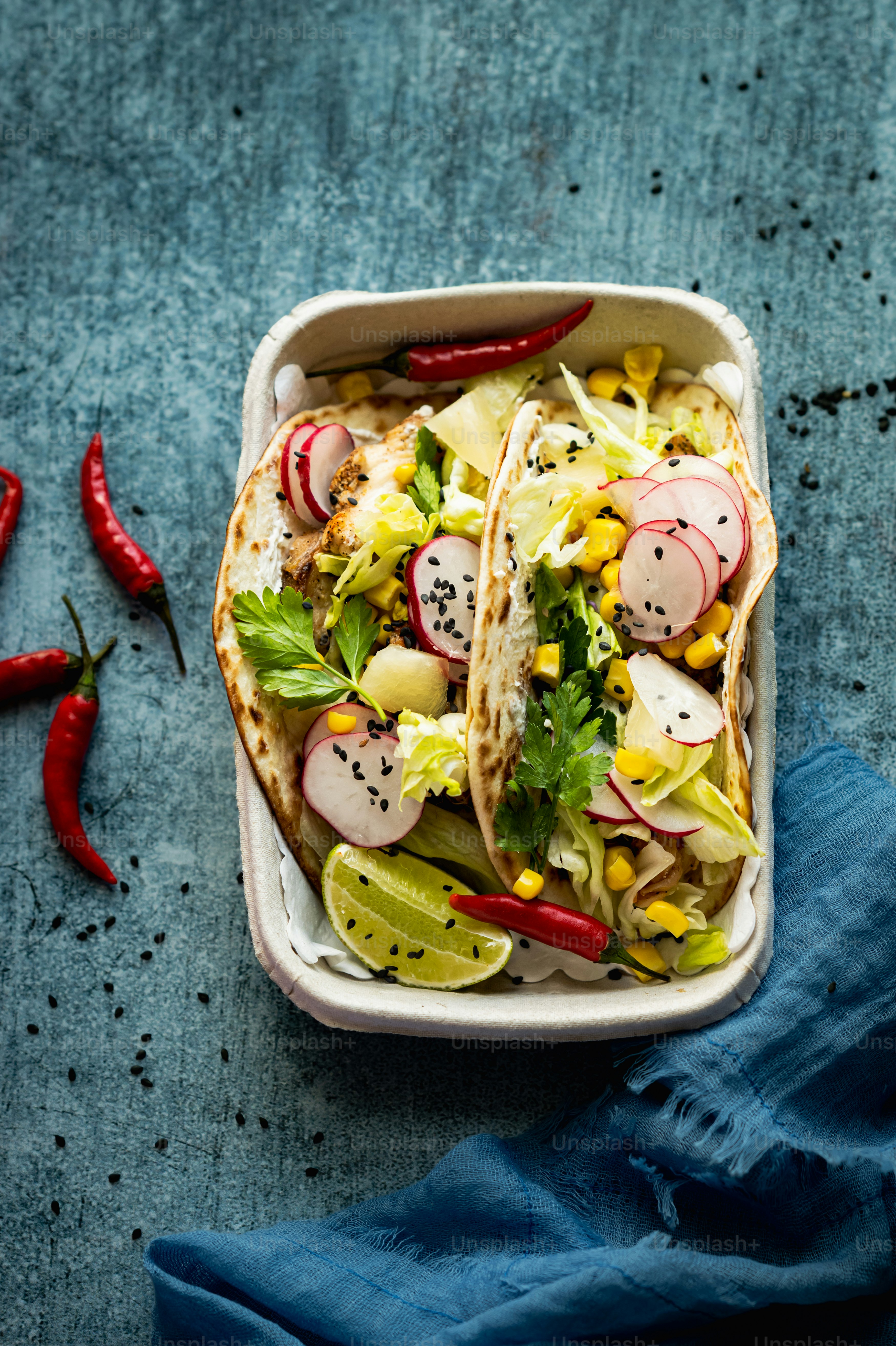 a plate of food with corn, avocado, and other vegetables