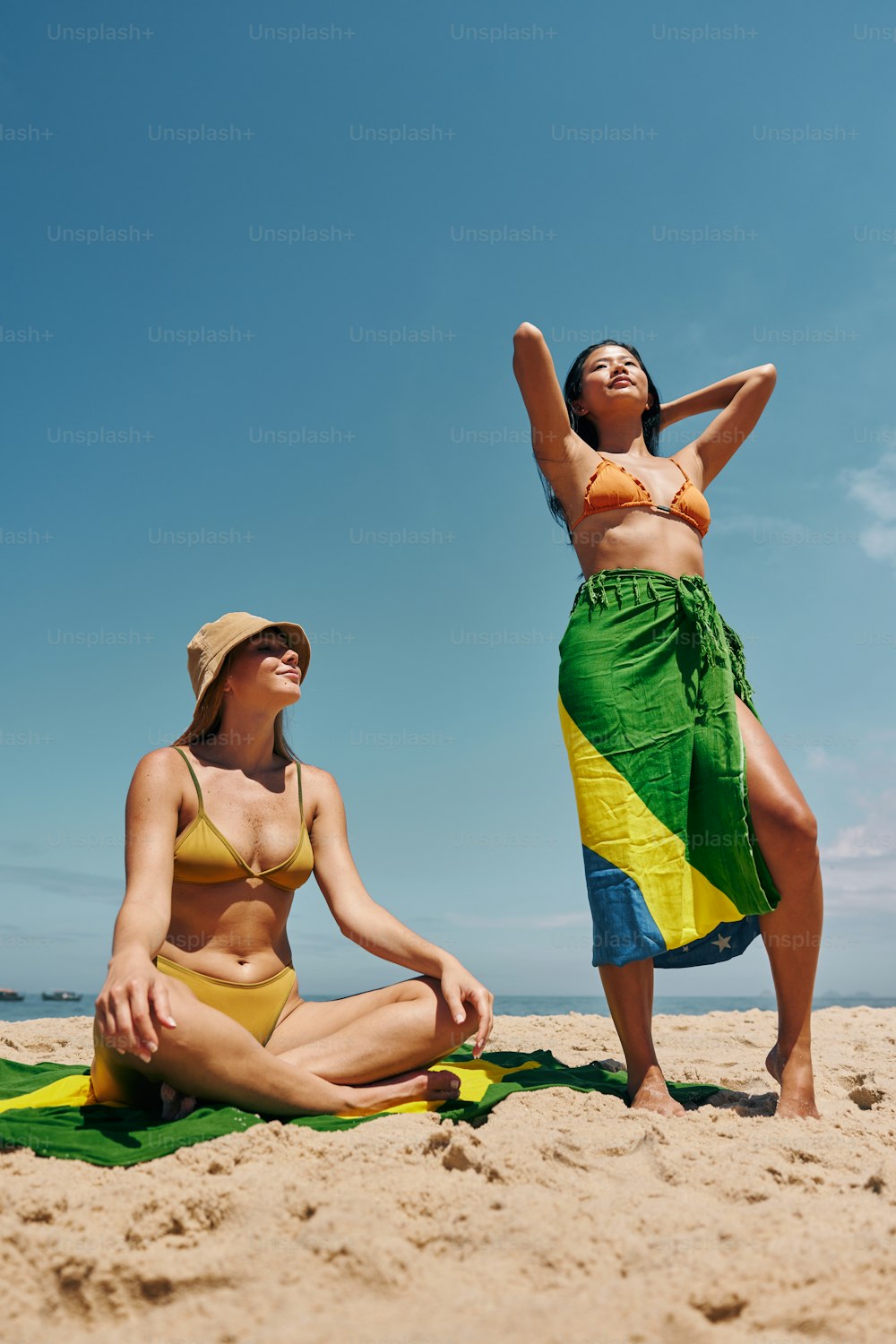 two women in bathing suits on a beach