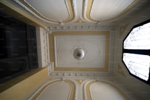 the ceiling of a room with a round window