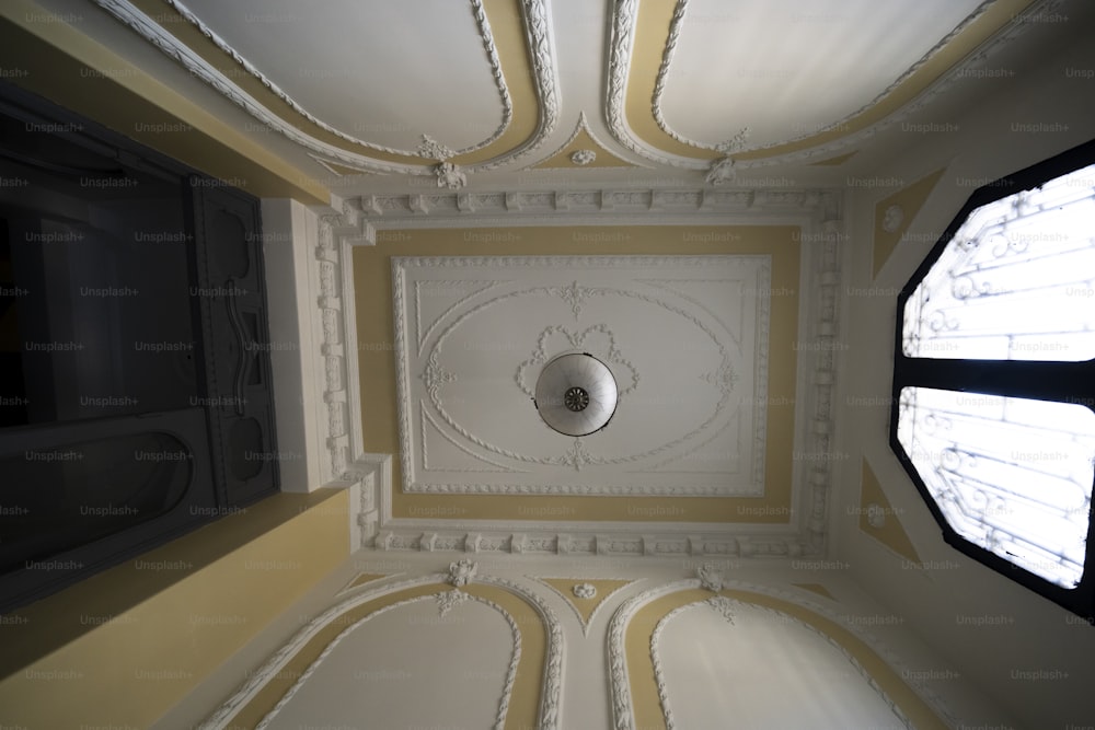 the ceiling of a room with a round window