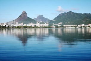 a large body of water with a city in the background