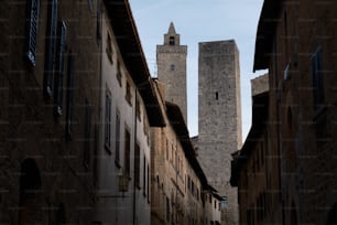 a tall tower towering over a city next to buildings