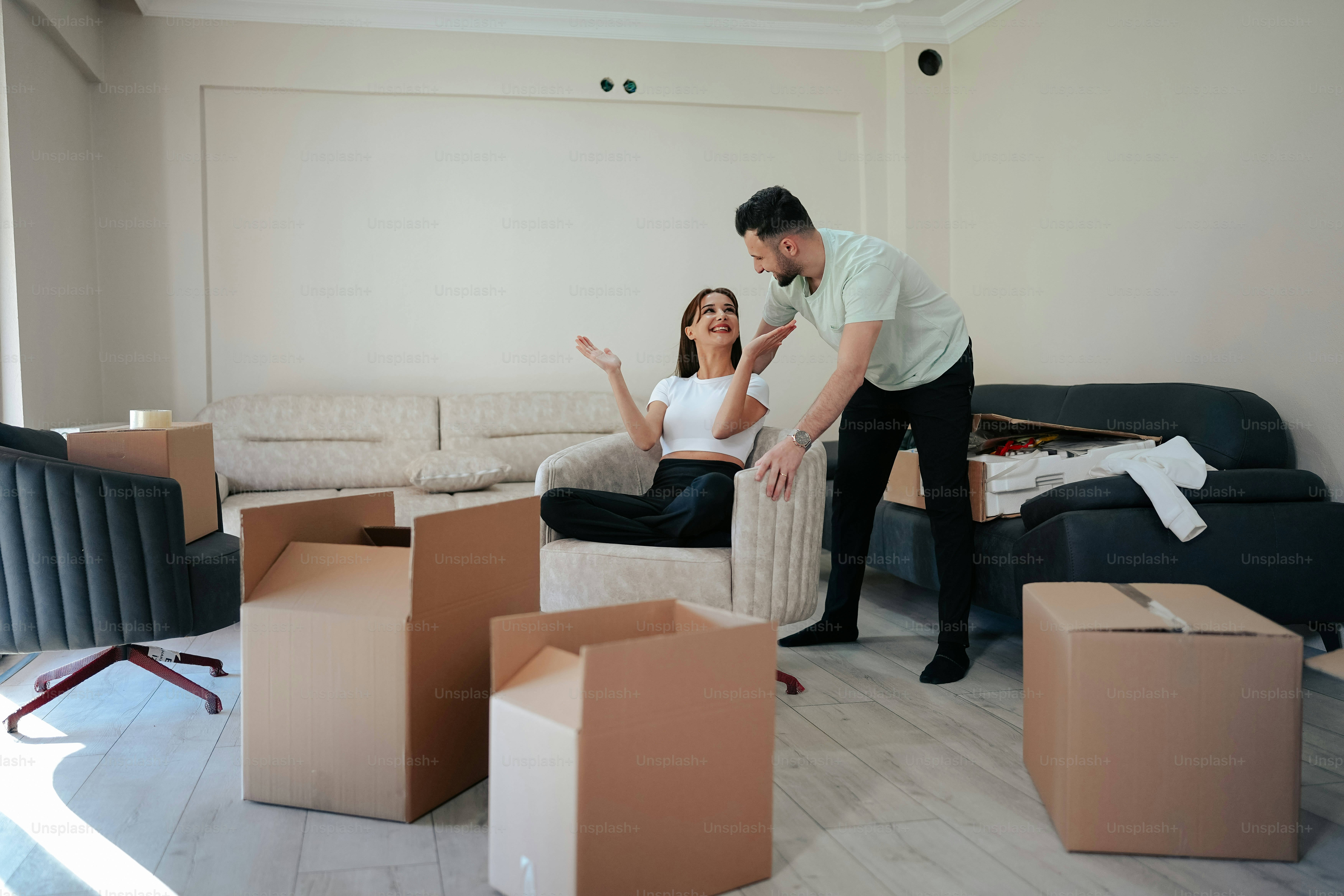 a man standing next to a woman in a living room