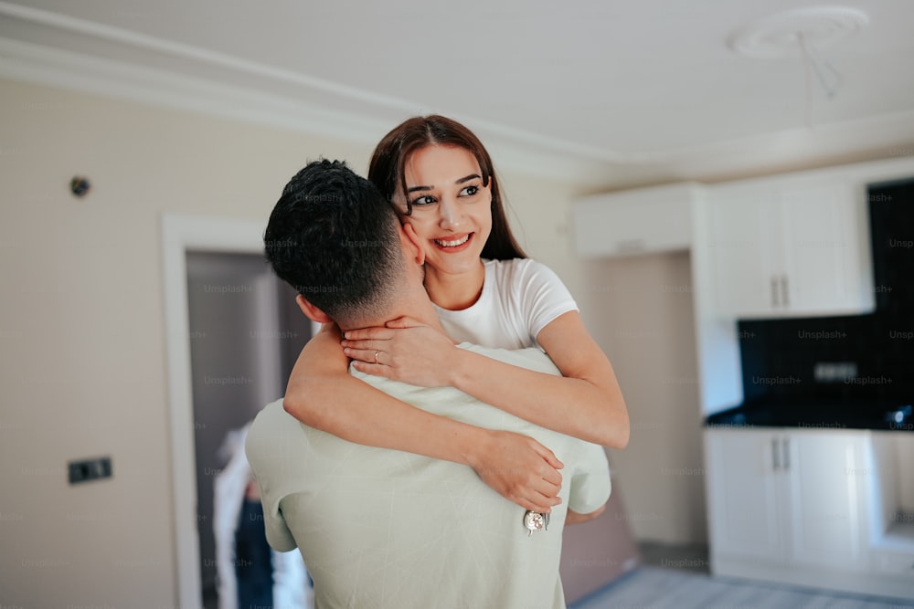 a woman hugging a man in a living room