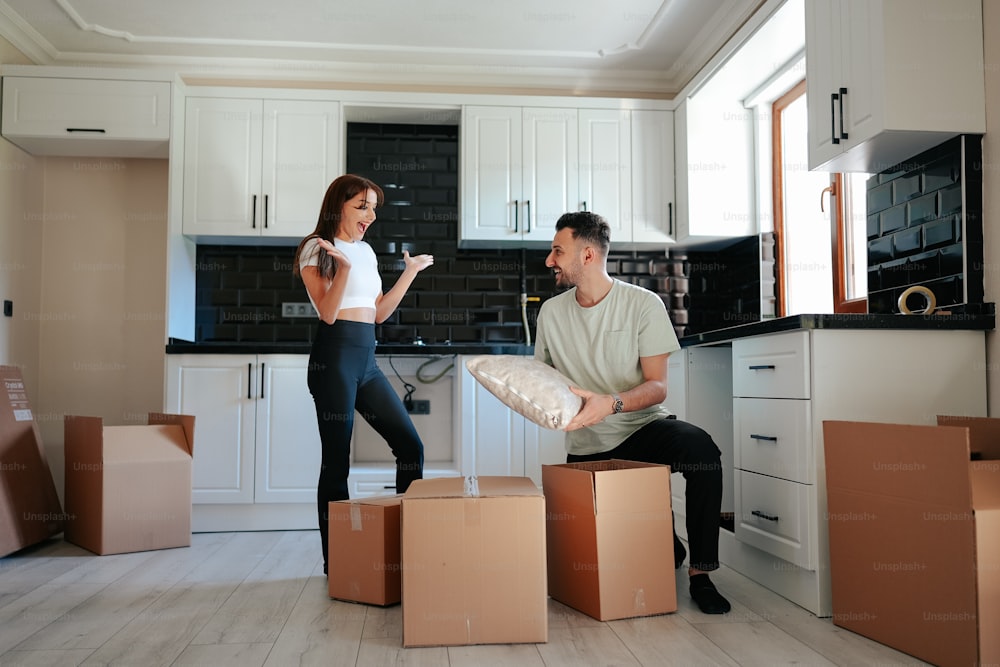 a man and a woman moving in to a new home