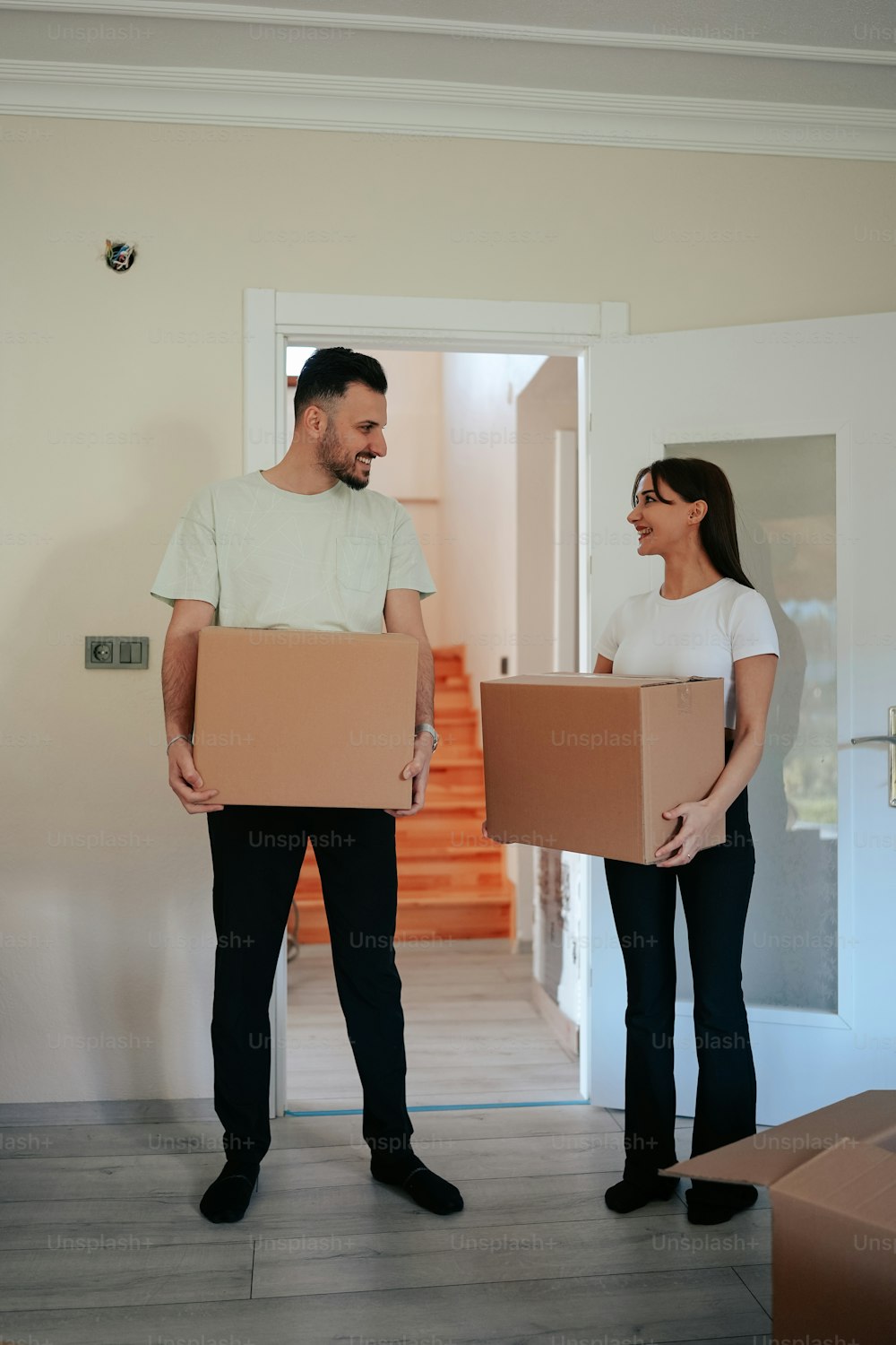 a man and a woman holding boxes in their hands