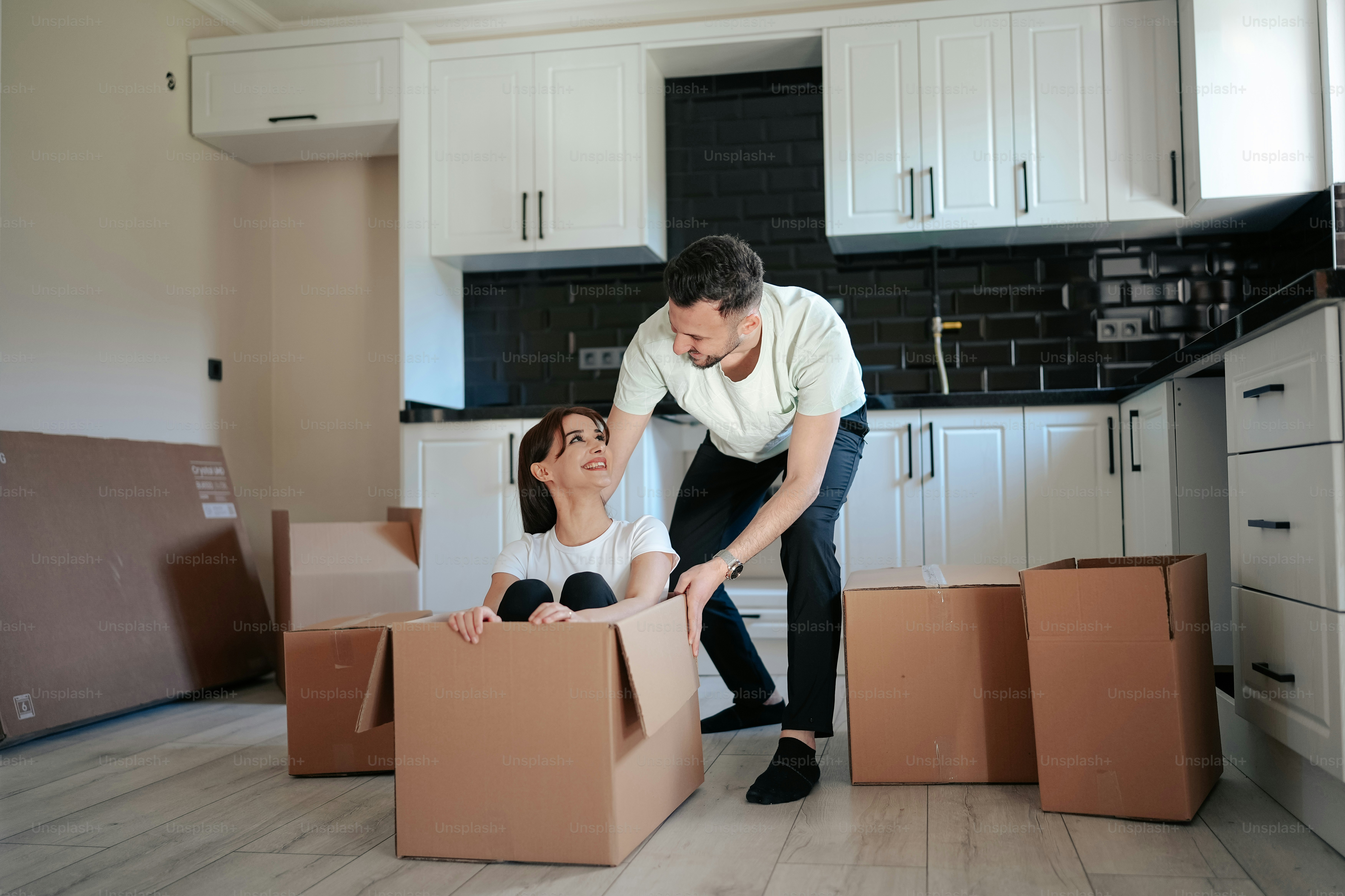 A man and a woman moving in to a new home photo – Moving in together ...