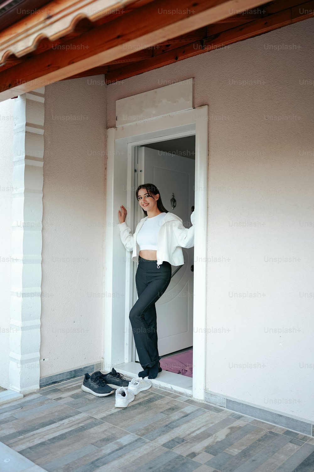 a woman standing in a doorway of a house