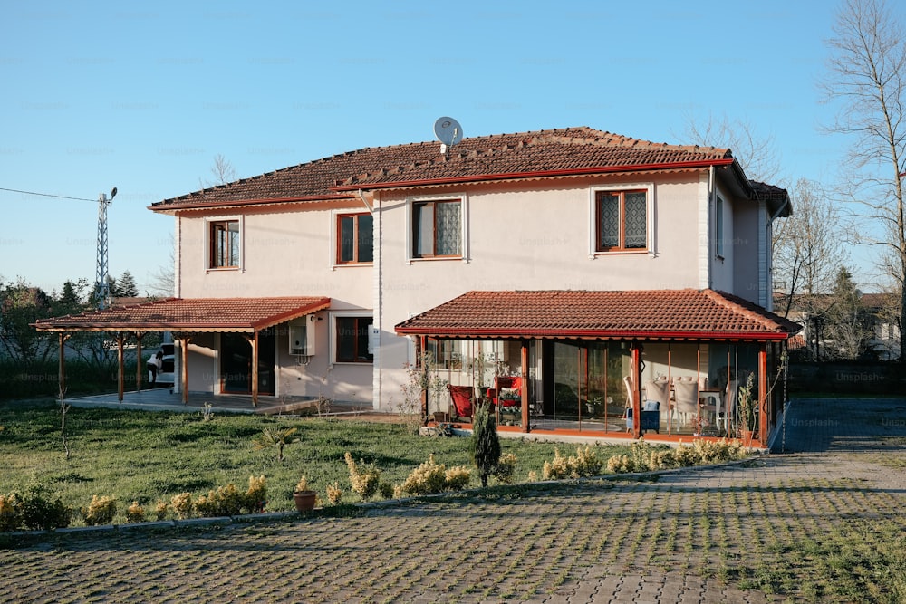 a white house with a red tiled roof