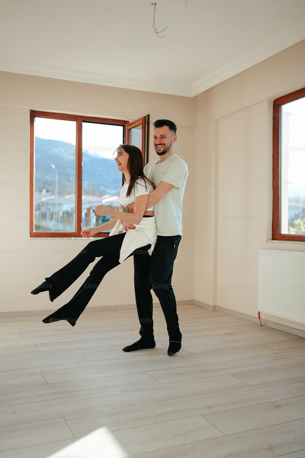 a man and a woman are dancing in a room