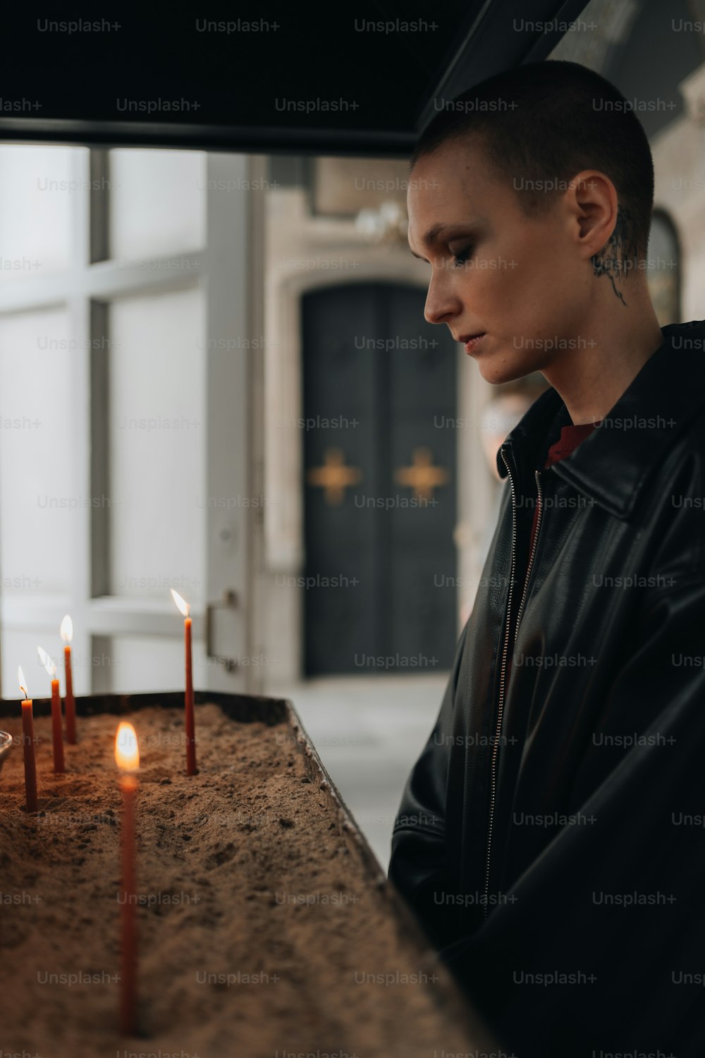 a man standing in front of a table with candles