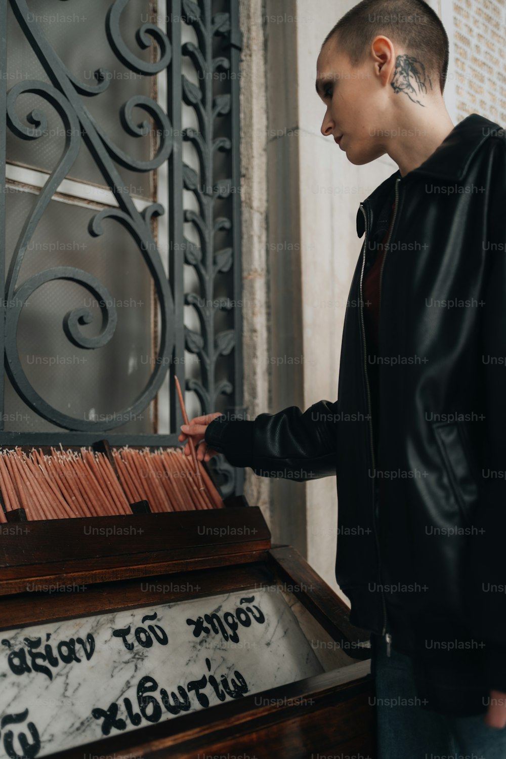a man standing next to a piano with writing on it