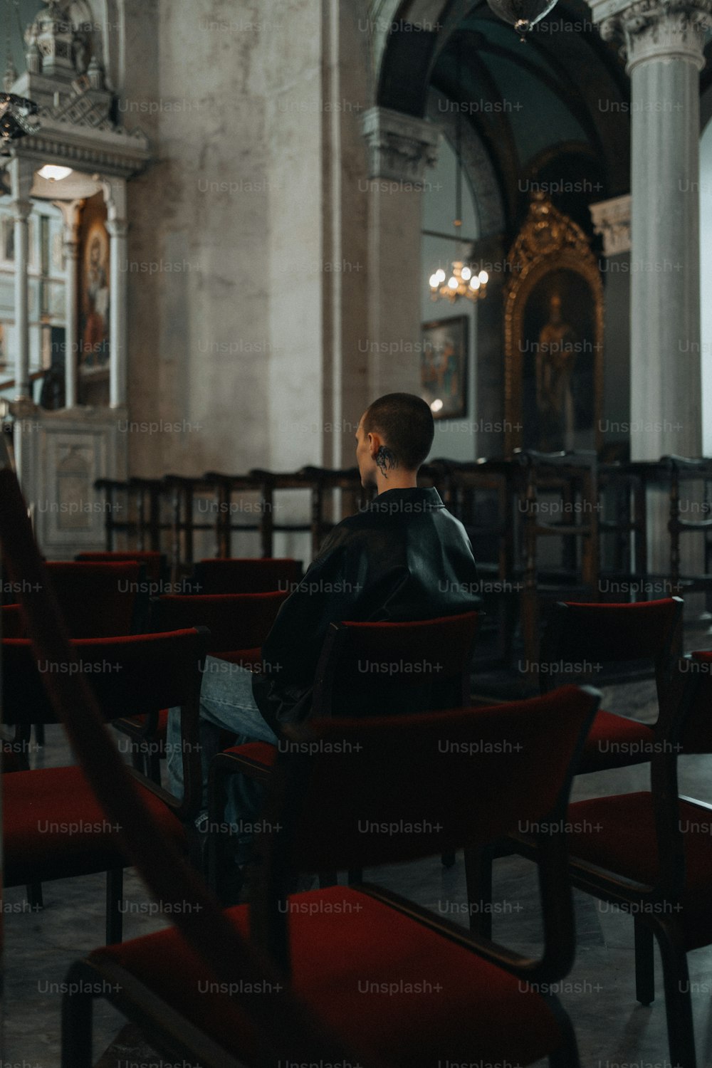 a person sitting in a chair in a church