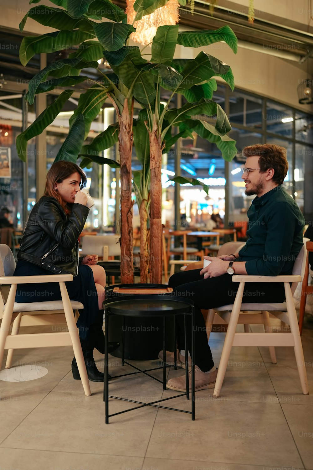 a man and a woman sitting at a table talking