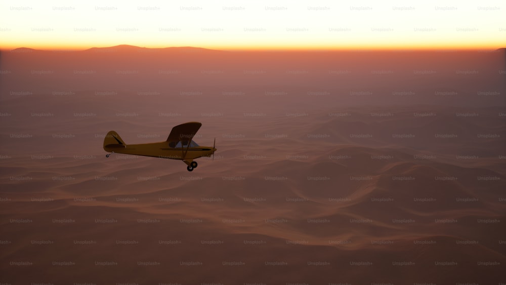 a small airplane flying over a desert at sunset