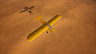 a yellow airplane flying over a sandy area