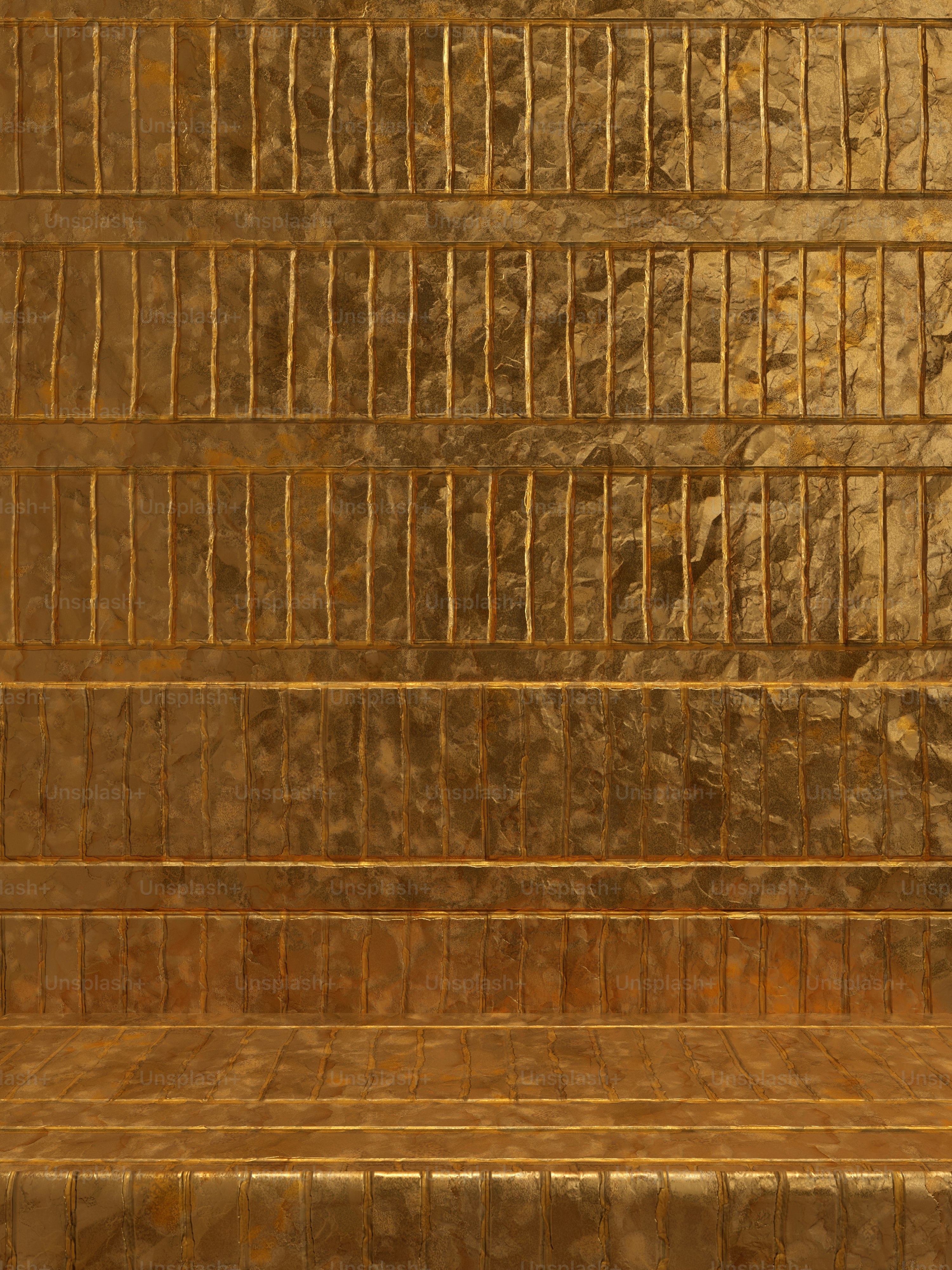 a gold tiled wall with a bench in front of it
