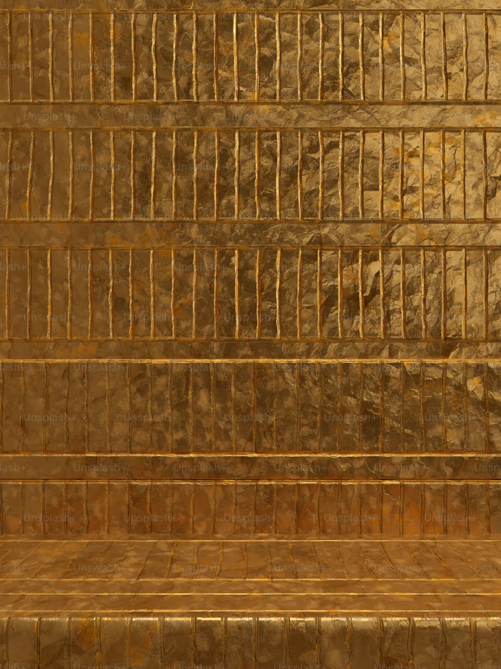 a gold tiled wall with a bench in front of it