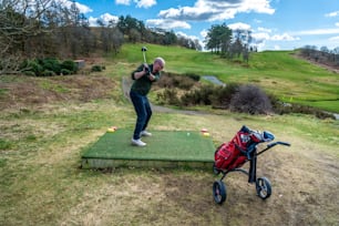 a man hitting a golf ball with a golf club