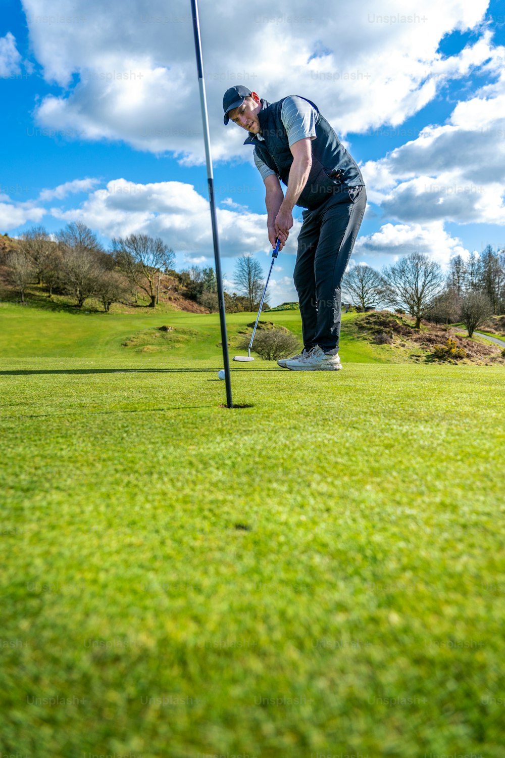 a man is playing golf on a sunny day