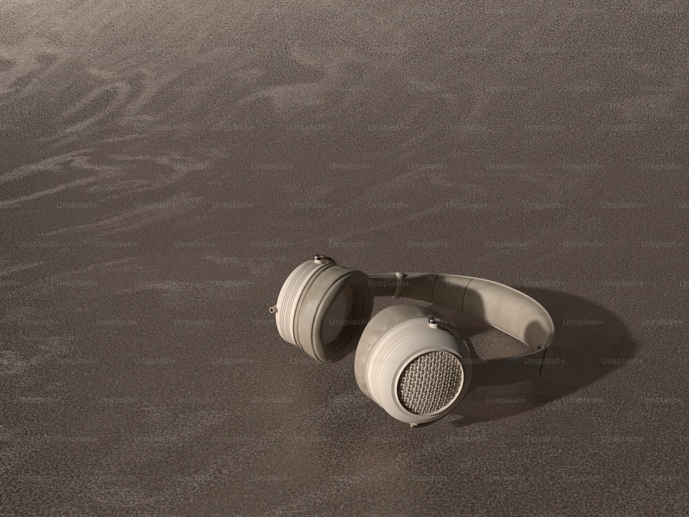 a pair of headphones laying on a beach