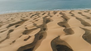 a sandy beach with a body of water in the background