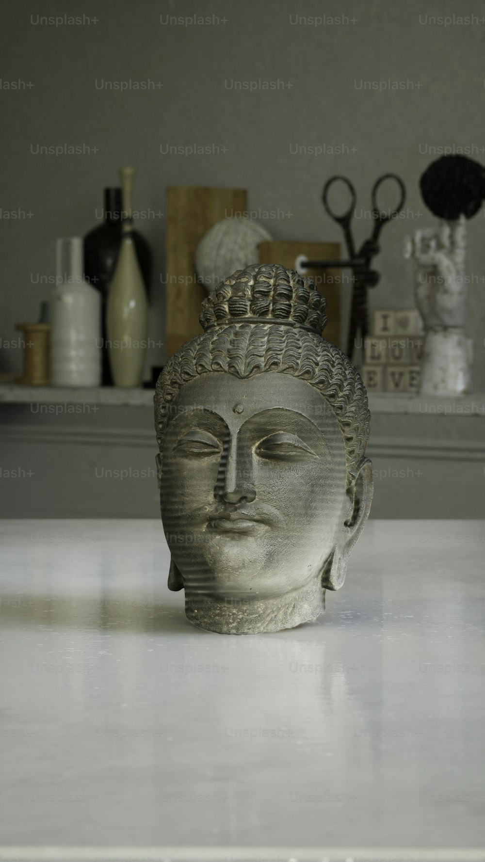 a buddha statue sitting on top of a white counter