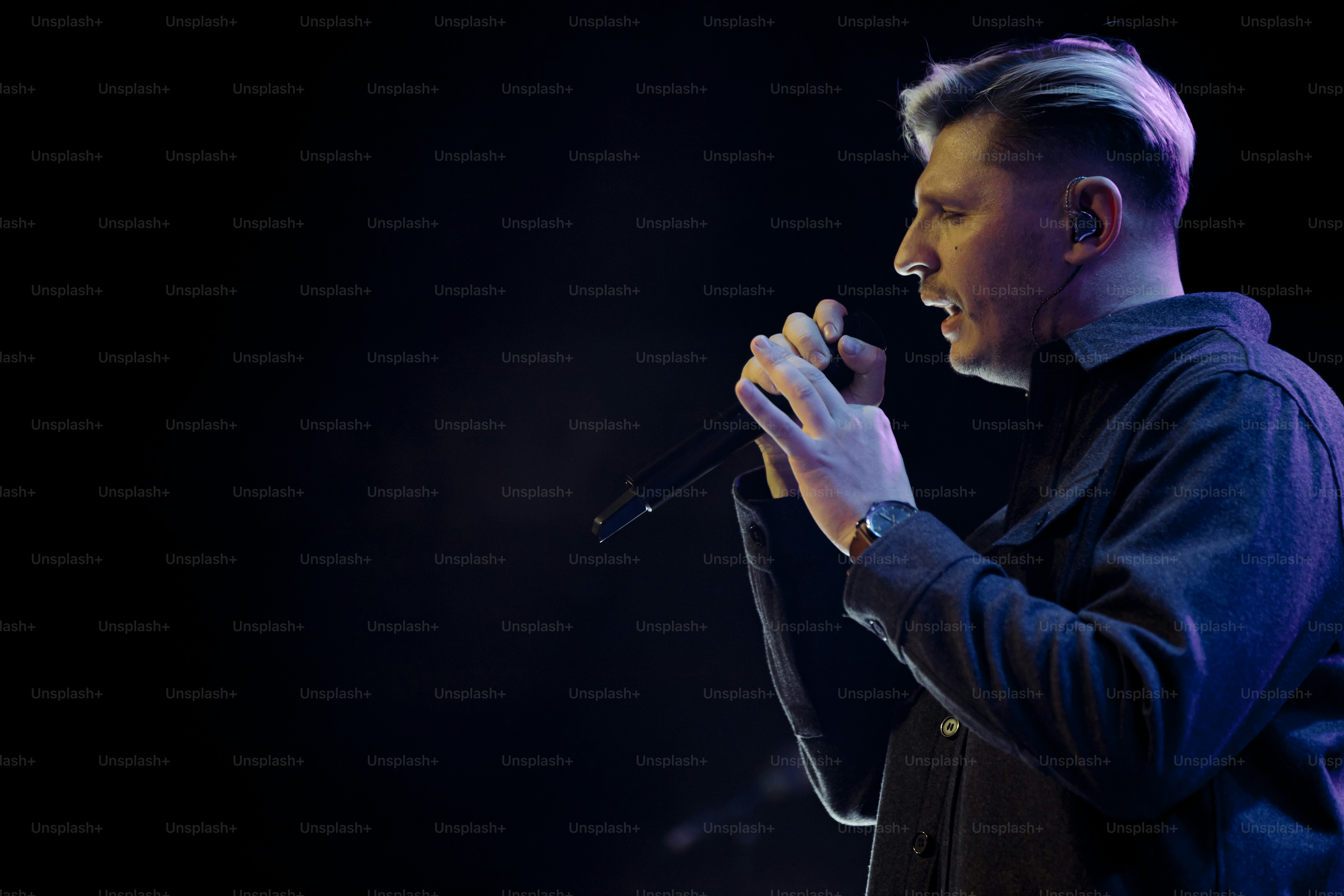 a man holding a microphone up to his mouth