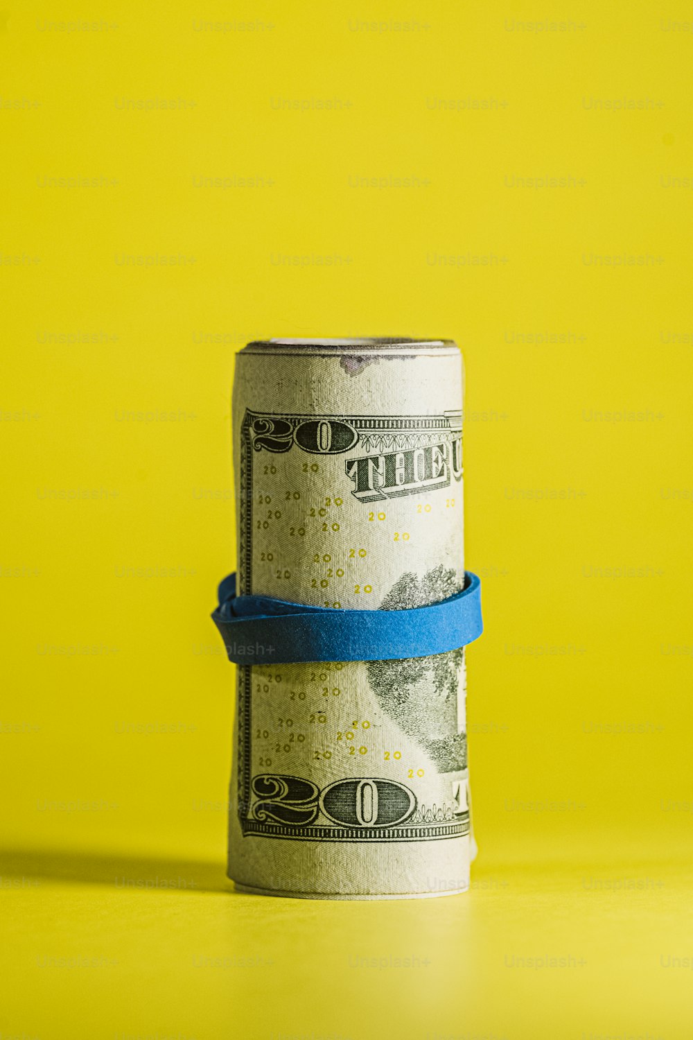a roll of money wrapped in a blue ribbon