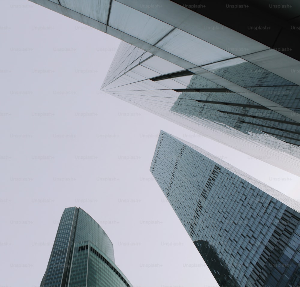 looking up at two skyscrapers from the ground