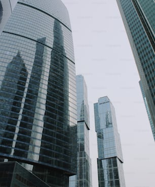 a group of tall buildings with a sky background