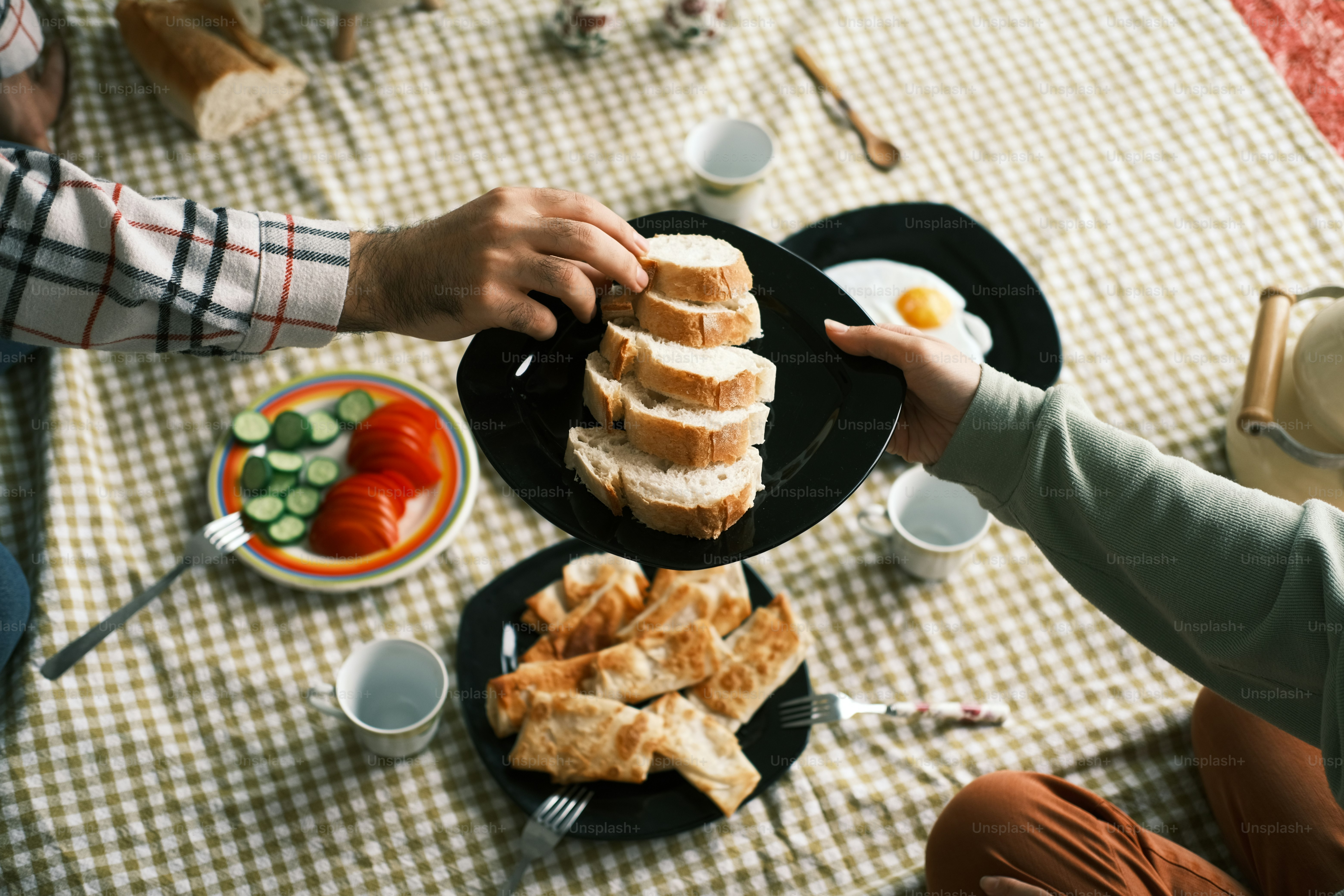 a man and a woman sitting at a table with plates of food