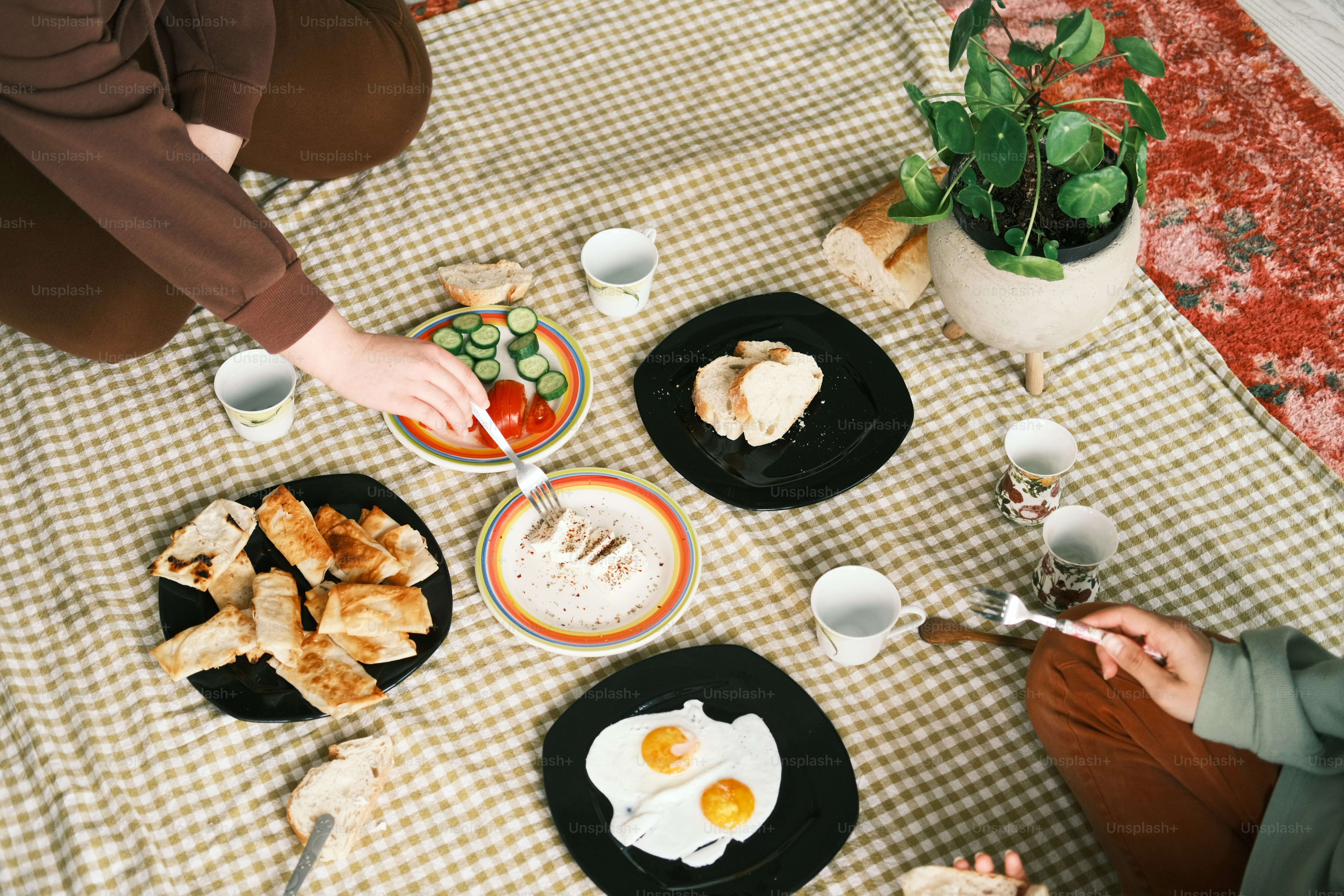 a person sitting at a table with plates of food
