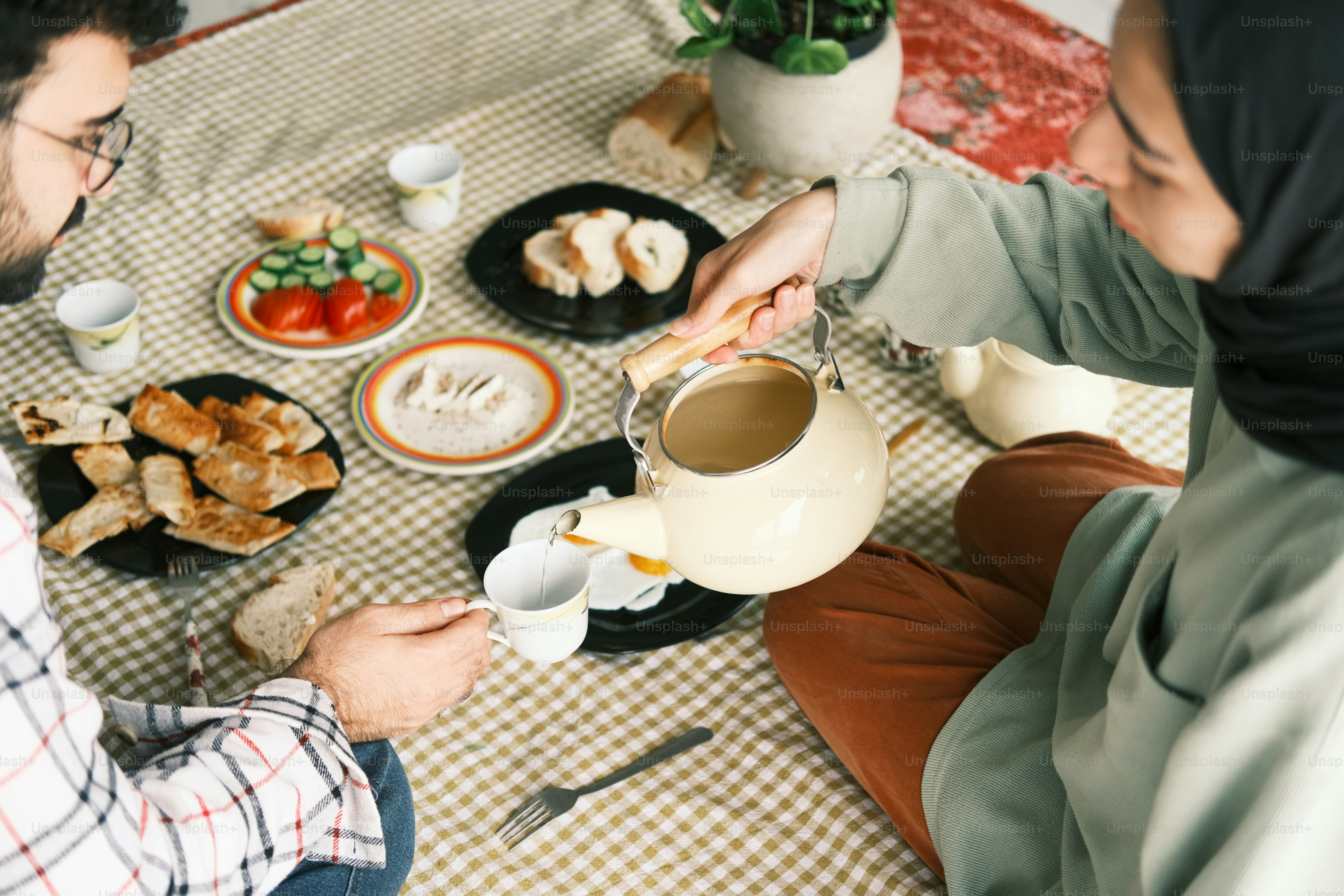 a couple of people sitting at a table with food